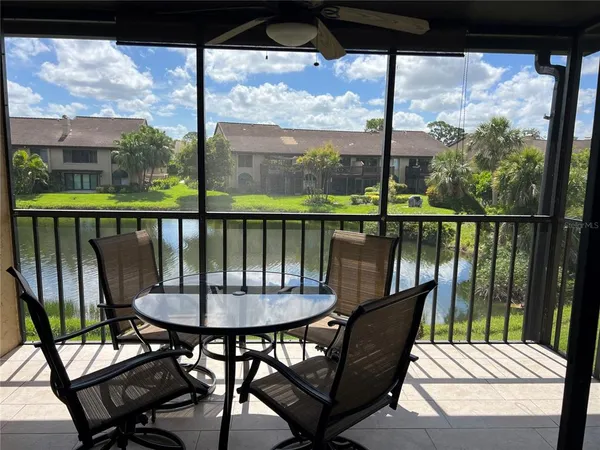 a view of a balcony with chairs and a table