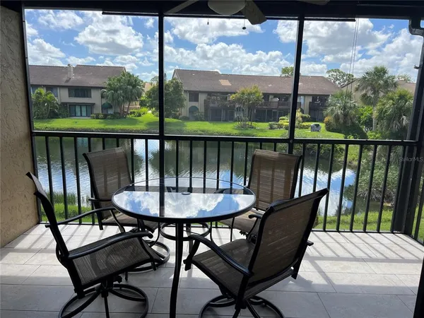 a view of a balcony with a table and chairs
