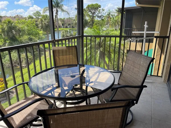 a view of a chairs and table in the balcony