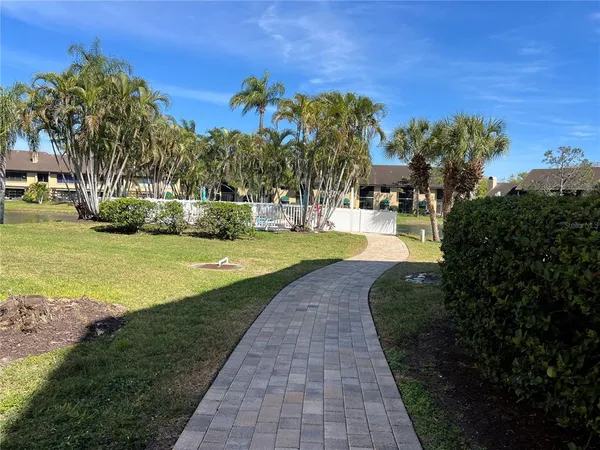 a view of a swimming pool with a yard and sitting area