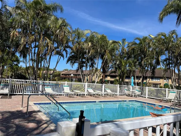 a view of a swimming pool with a yard