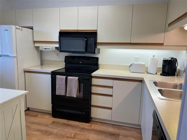 a kitchen with a sink and a refrigerator
