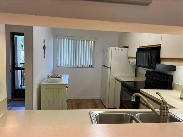 a kitchen with stainless steel appliances kitchen island a sink dishwasher a refrigerator and a stove