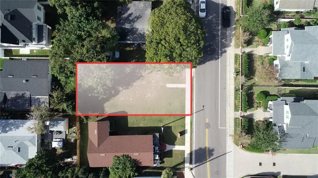 an aerial view of a house with a yard and garden
