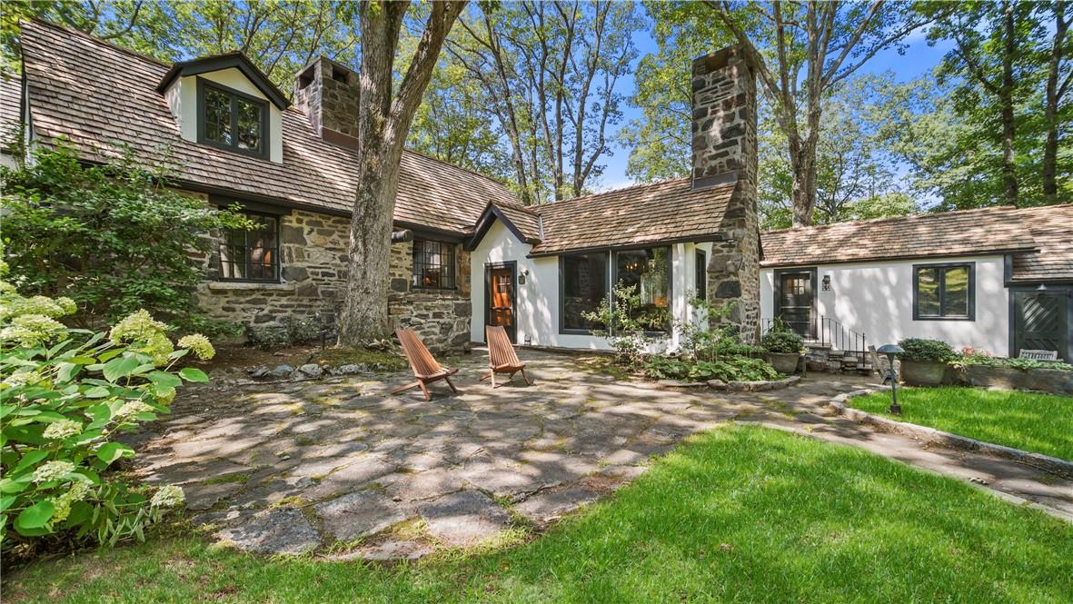 60 Cabin Ridge Road Chappaqua, NY 10514 - Photo 1 of 1 a view of a brick house with a large windows and large tree