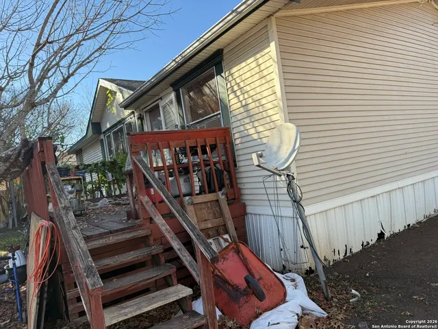 a view of a house with backyard porch and sitting area