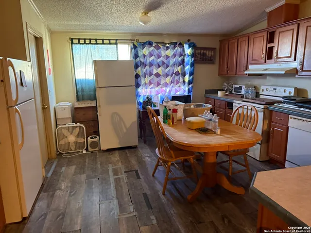 a dining room with furniture and a refrigerator