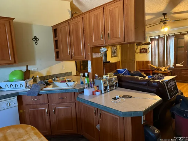 a kitchen with a sink a stove and a refrigerator