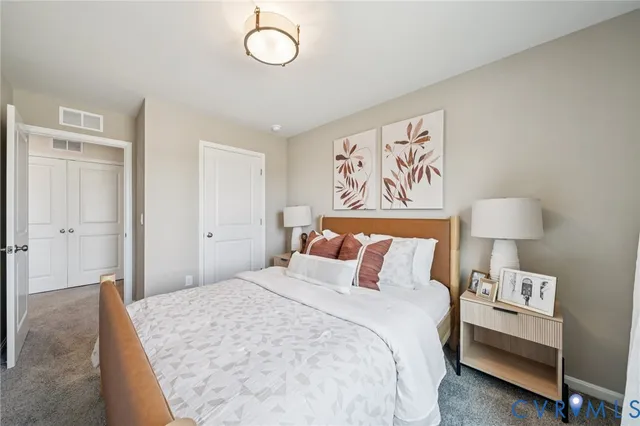 a bedroom with a bed and a lamp