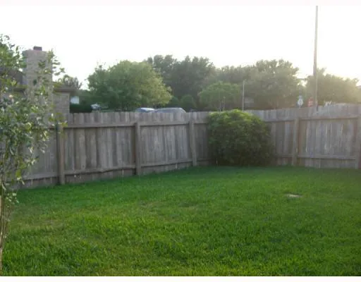 a view of a backyard with a fence