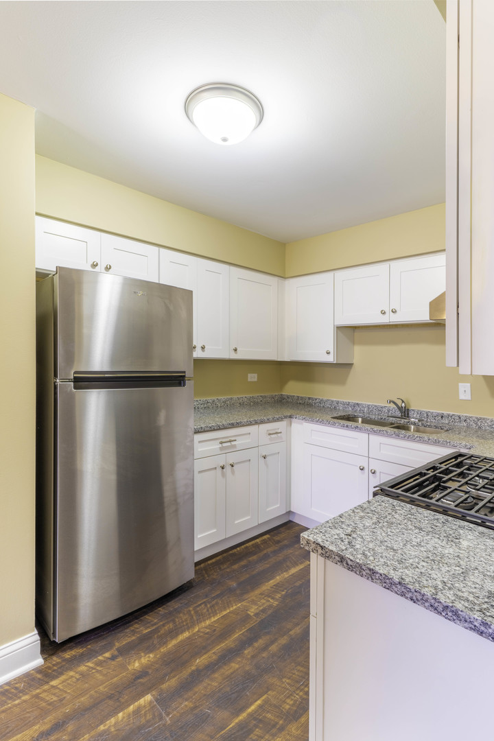 5700 South Archer Avenue, Unit 3A Chicago, IL 60638 - Photo 5 of 11 a kitchen with a refrigerator a stove a microwave and cabinets