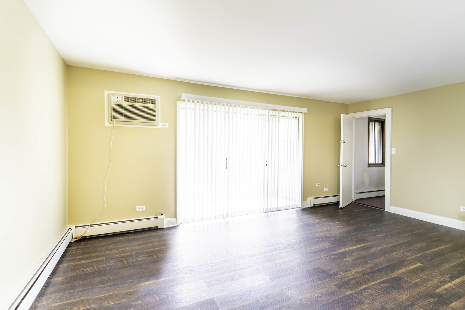 5700 South Archer Avenue, Unit 3A Chicago, IL 60638 - Photo 7 of 11 an empty room with wooden floor and closet