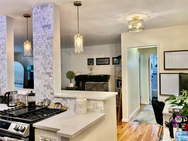a kitchen with a stove and a chandelier