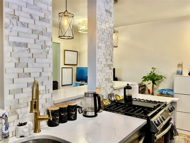 a kitchen with stainless steel appliances a stove a sink and a microwave