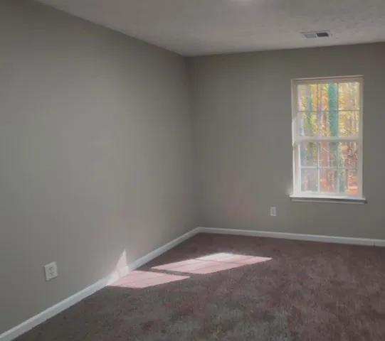 a bathroom with a granite countertop sink toilet and a mirror