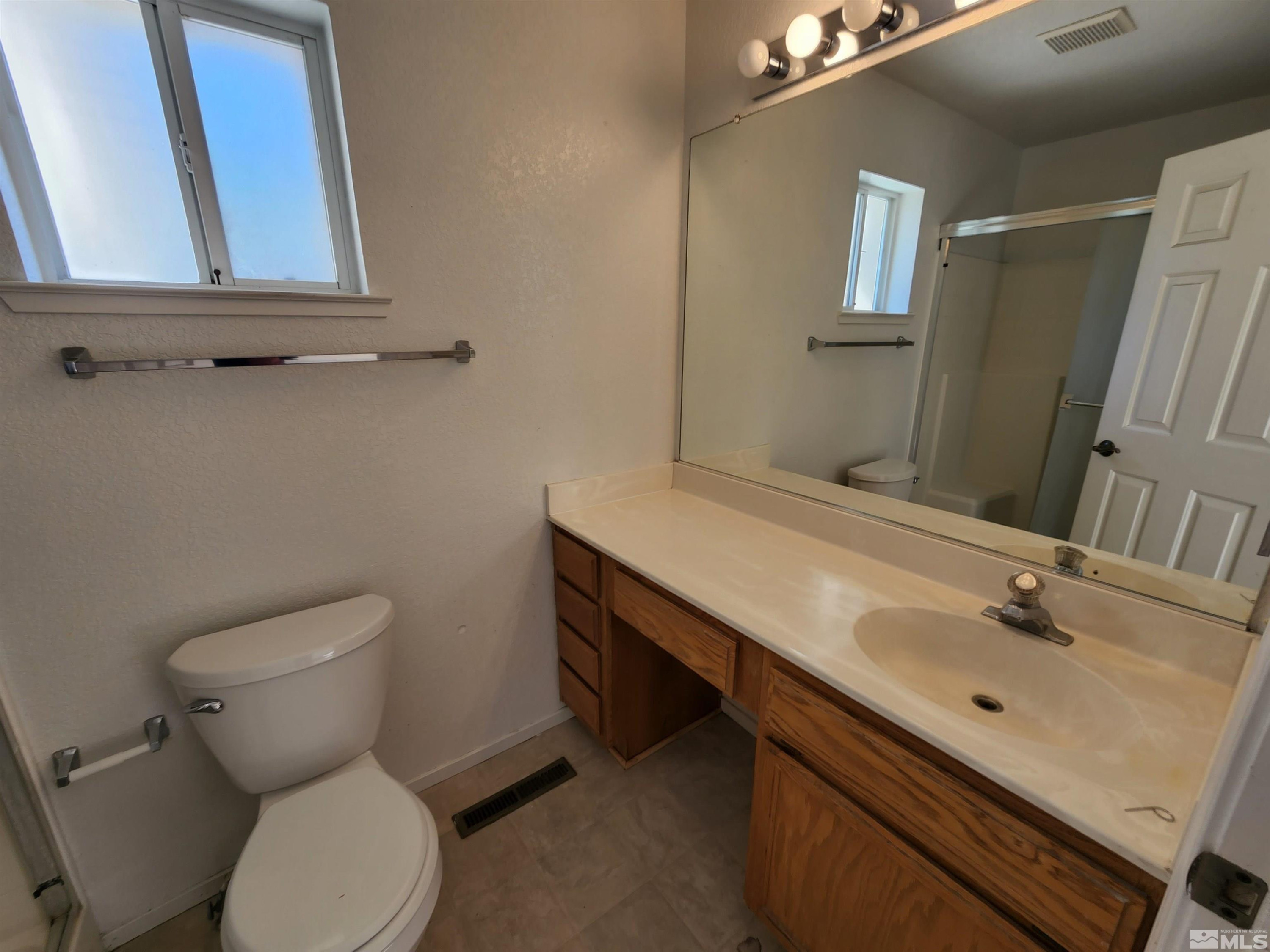 608 Boulder Circle Dayton, NV 89403 - Photo 13 of 22 a bathroom with a toilet sink and mirror