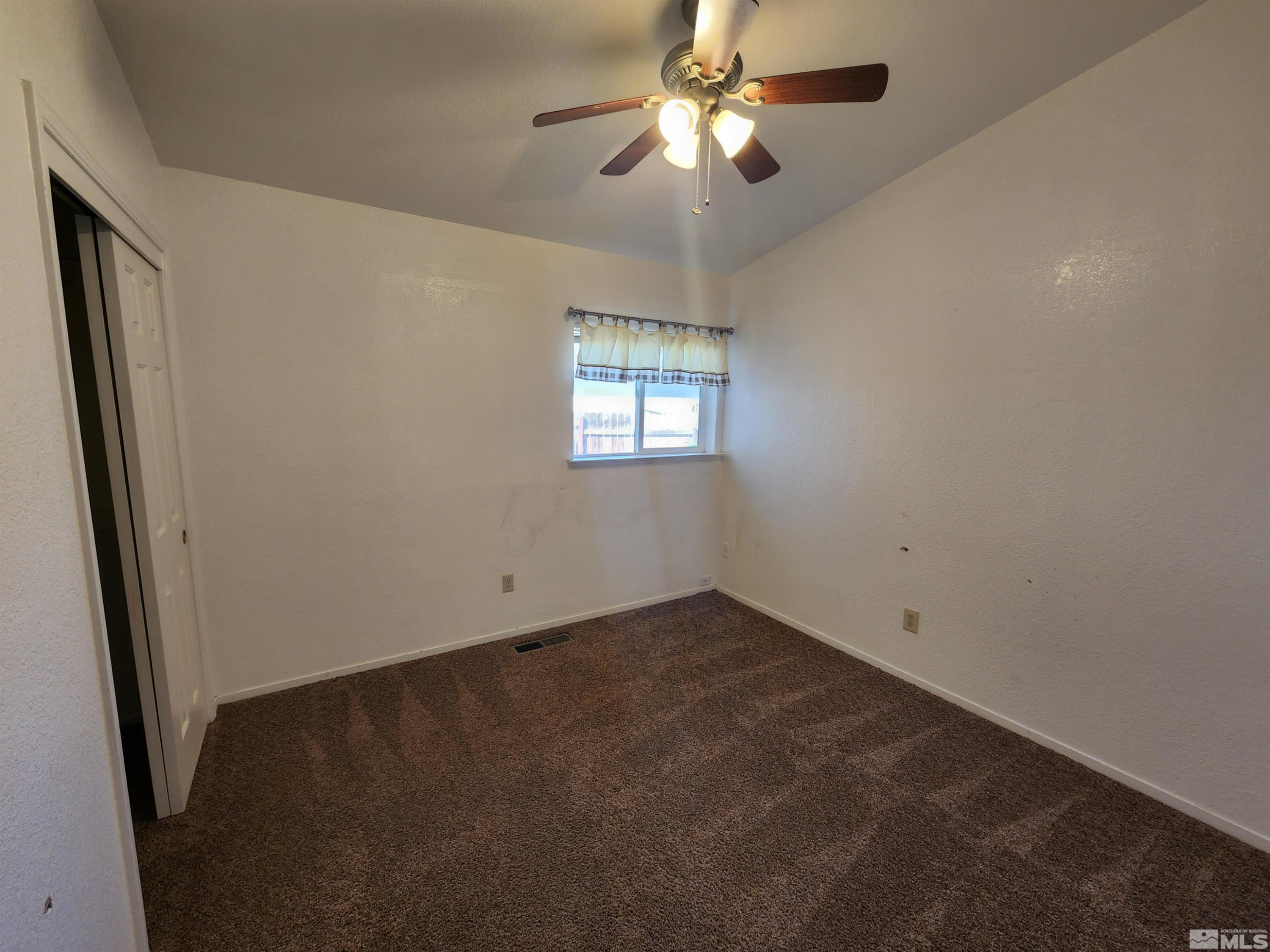 608 Boulder Circle Dayton, NV 89403 - Photo 15 of 22 an empty room with windows and fan
