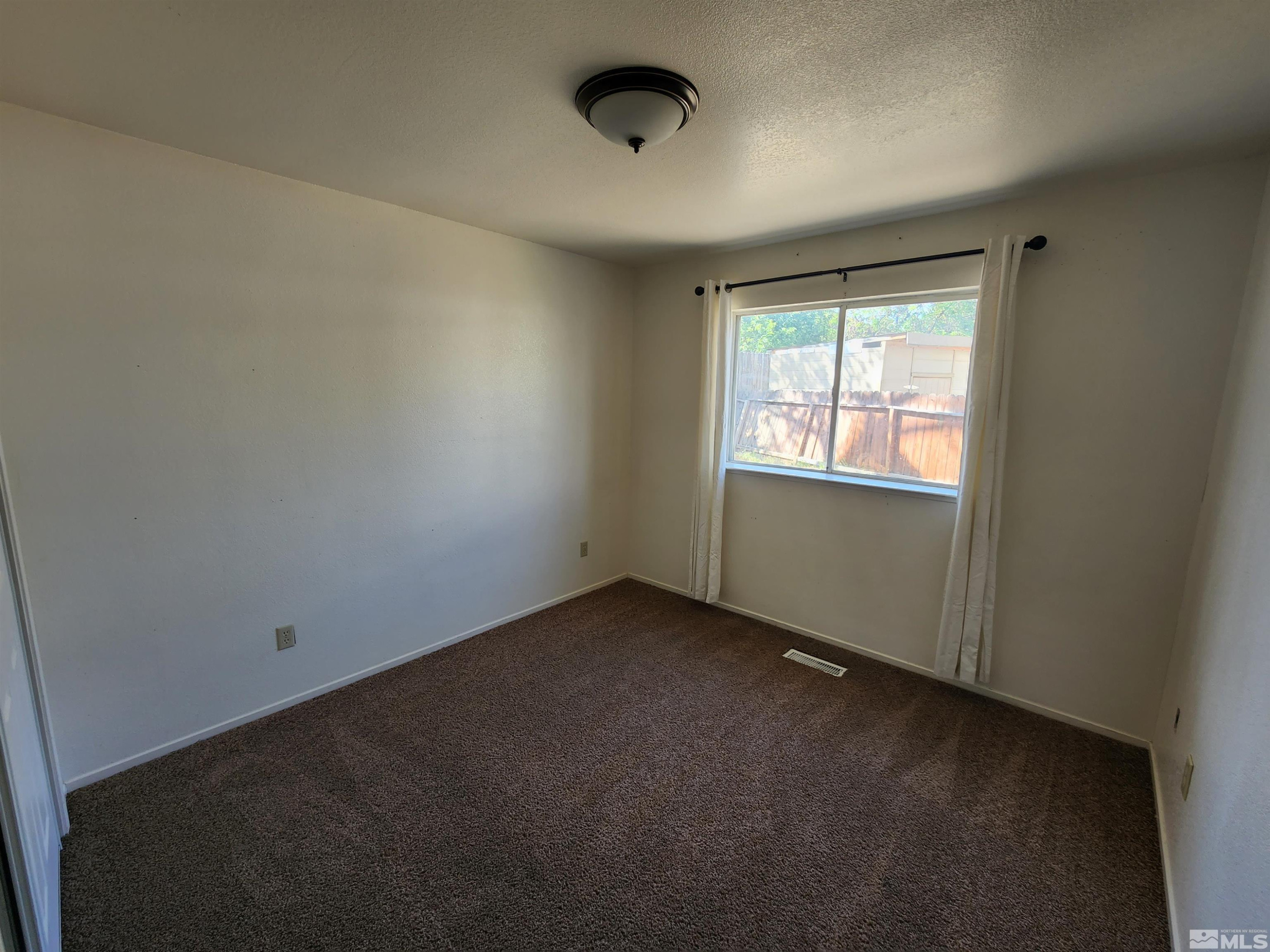 608 Boulder Circle Dayton, NV 89403 - Photo 16 of 22 an empty room with a window