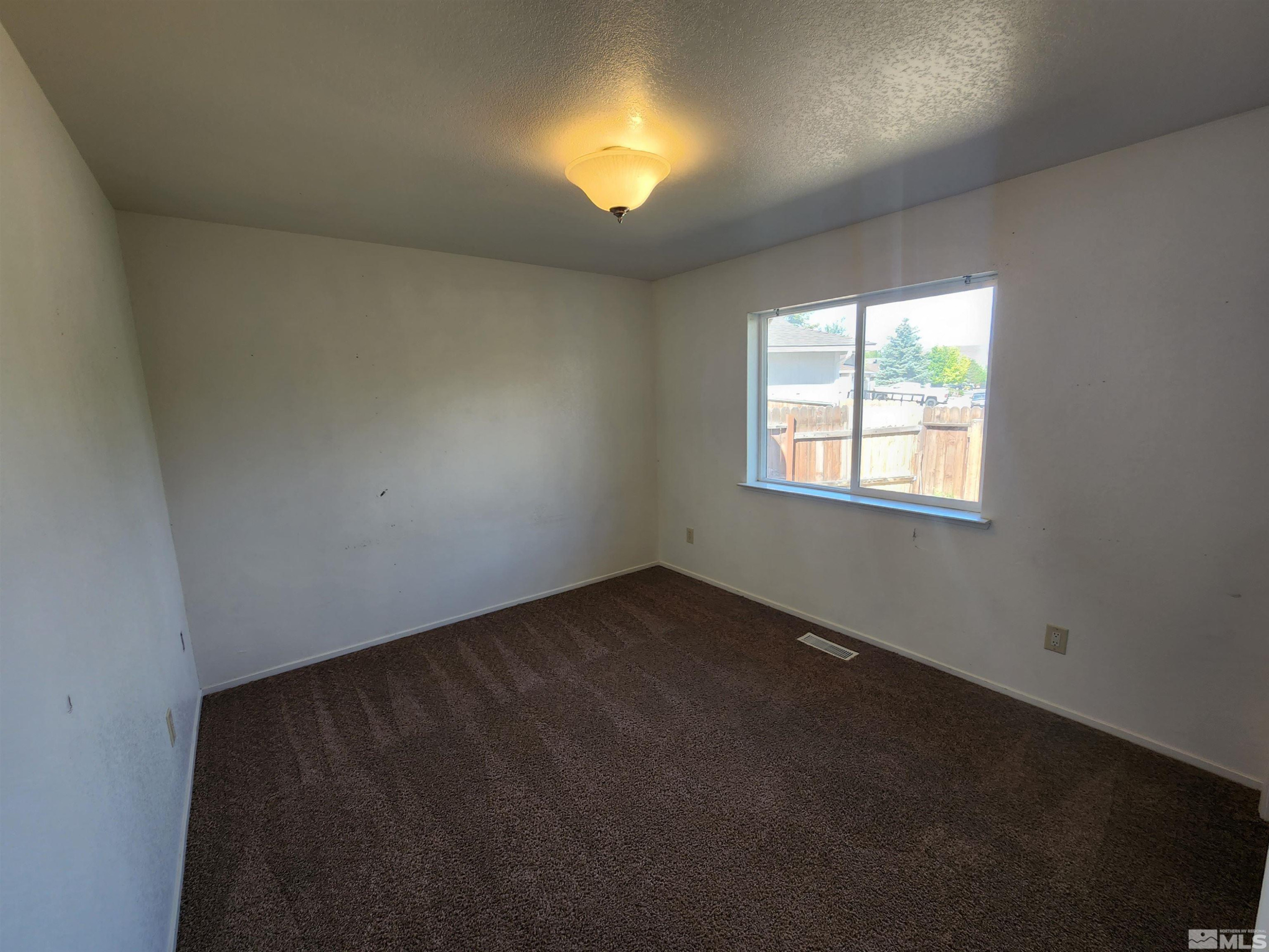 608 Boulder Circle Dayton, NV 89403 - Photo 17 of 22 an empty room with a window