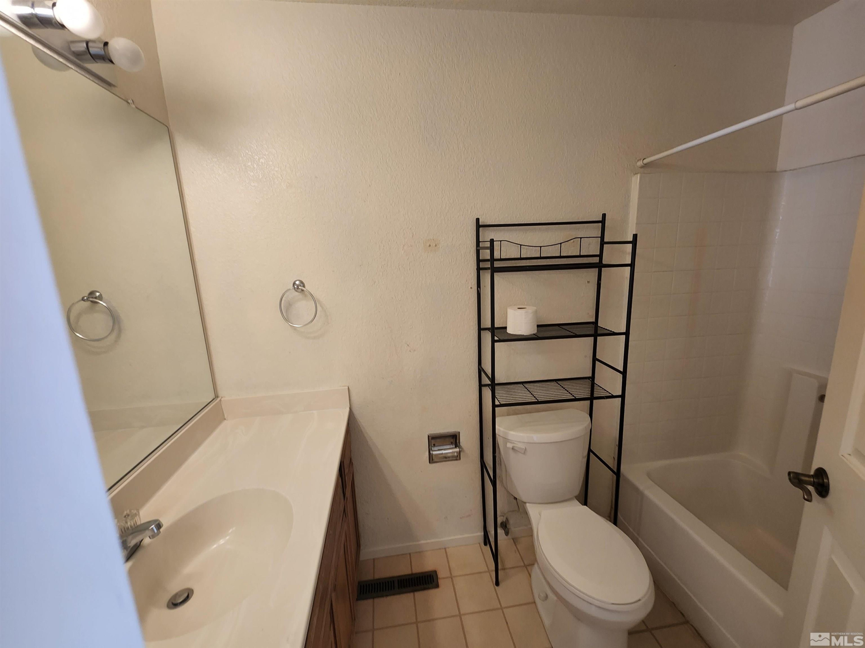 608 Boulder Circle Dayton, NV 89403 - Photo 19 of 22 a white toilet sitting next to a bath tub