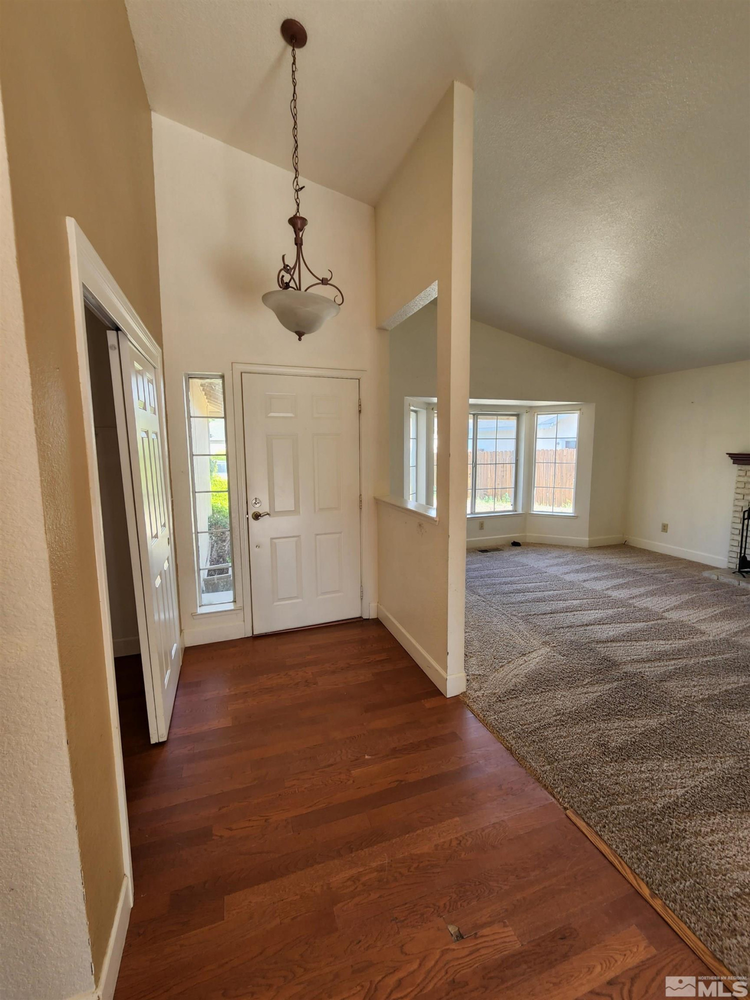 608 Boulder Circle Dayton, NV 89403 - Photo 3 of 22 a view of an empty room with window and wooden floor