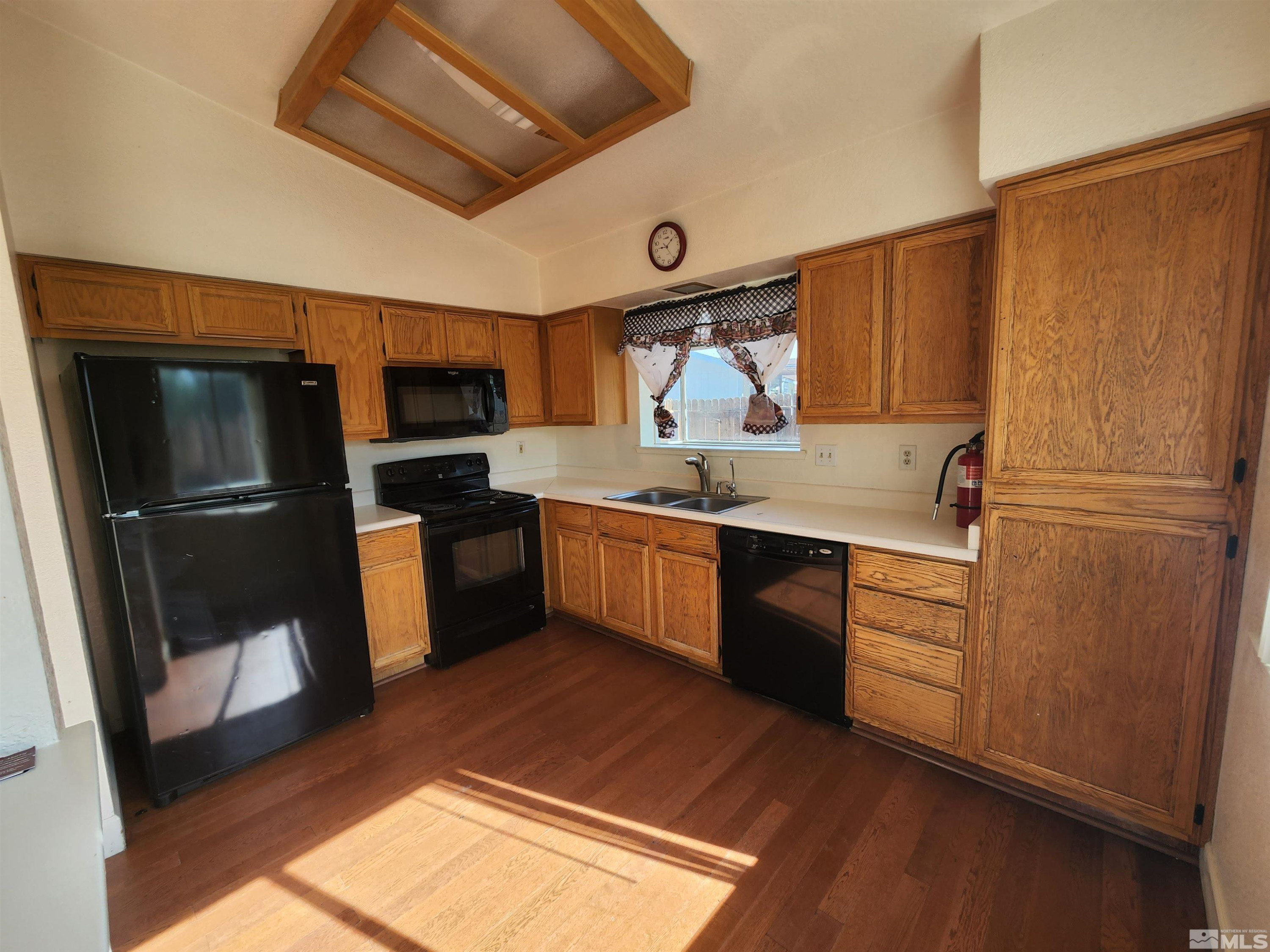 608 Boulder Circle Dayton, NV 89403 - Photo 7 of 22 a kitchen with a refrigerator sink and wooden floor