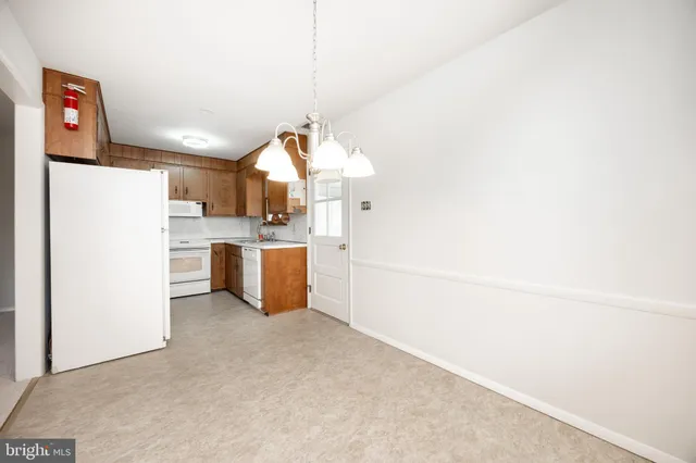 a kitchen with stainless steel appliances a refrigerator sink and cabinets
