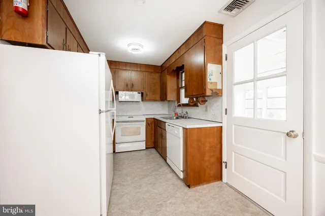 a kitchen with stainless steel appliances granite countertop a sink and a stove
