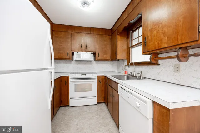 a kitchen with a sink cabinets and window