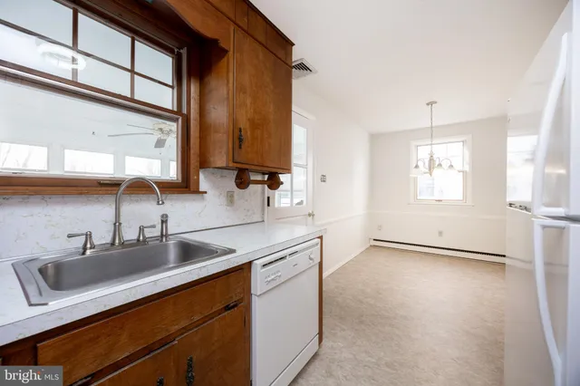 a kitchen with sink cabinets and window