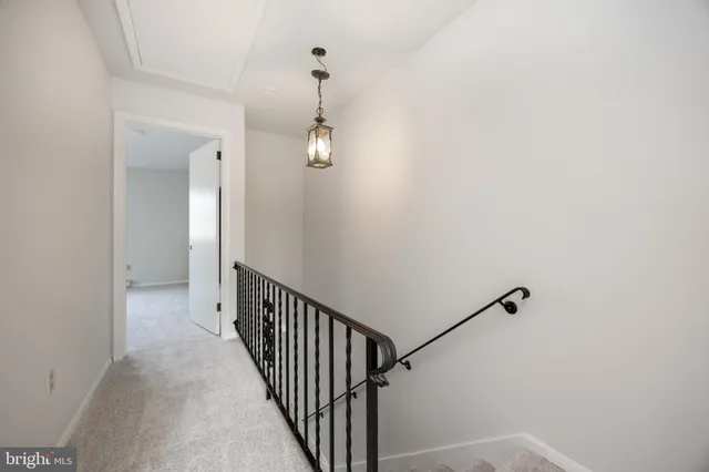 an empty room with windows and ceiling fan view