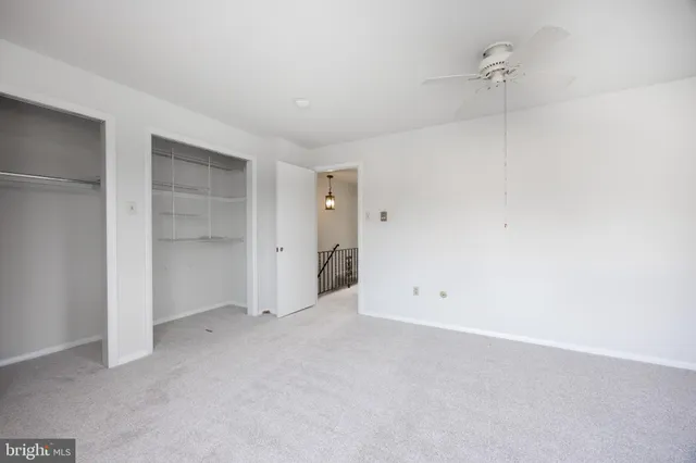 an empty room with windows and chandelier
