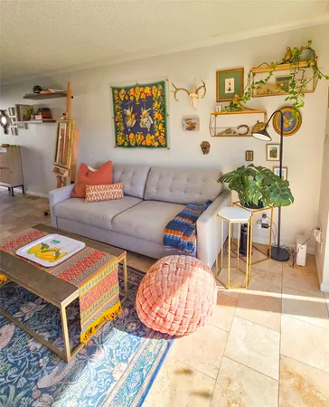 a living room with furniture and painting on the wall