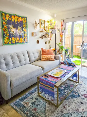 a living room with furniture and a rug