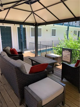 a outdoor sitting area with furniture and umbrella