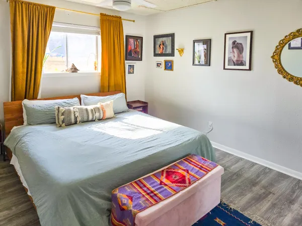 a bedroom with a bed and wooden floor