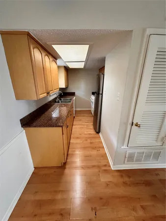 a view of a kitchen cabinets and a wooden floor
