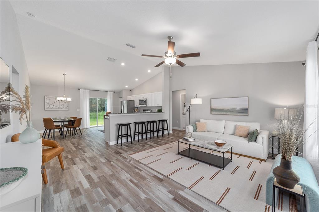 8571 Southwest 131st Place Ocala, FL 34473 - Photo 5 of 32 a living room with furniture a two lamp and a ceiling fan