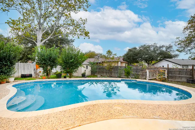 a view of swimming pool with a yard