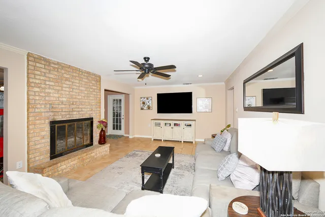 a living room with furniture a flat screen tv and a fireplace