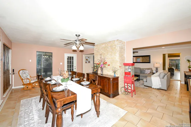 a dining room with furniture and chandelier