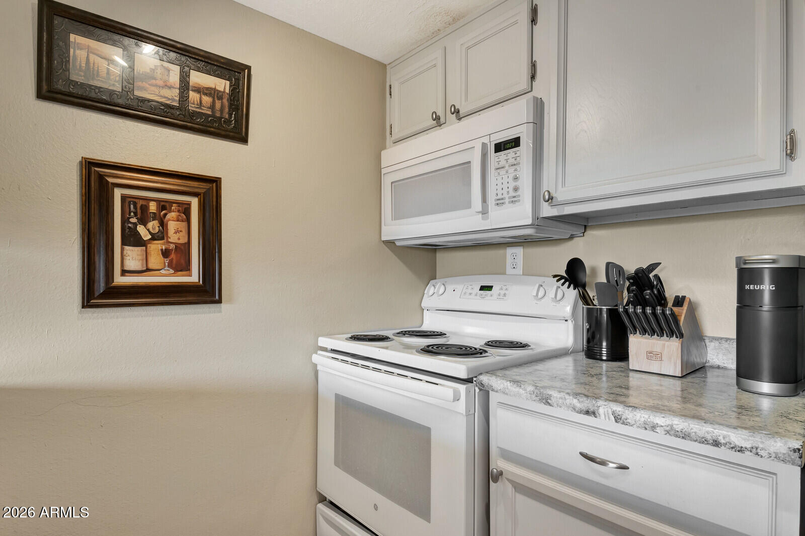 7436 East Chaparral Road, Unit B228 Scottsdale, AZ 85250 - Photo 11 of 17 a kitchen with stainless steel appliances granite countertop white cabinets and a stove top oven