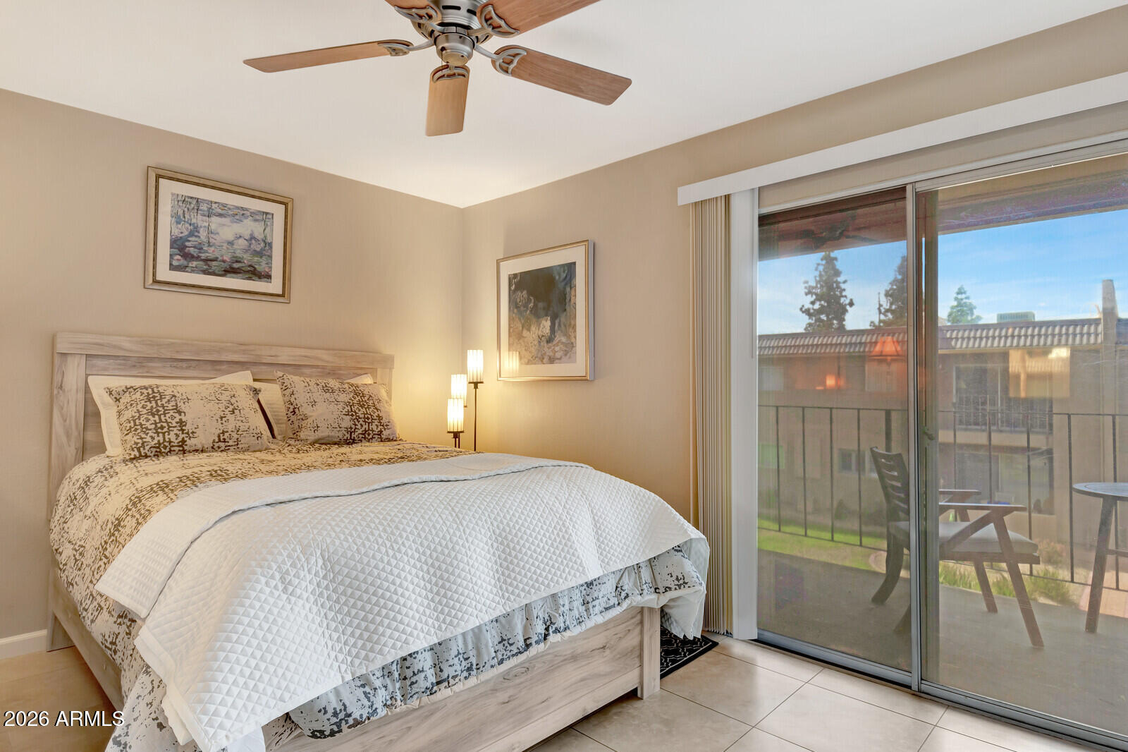7436 East Chaparral Road, Unit B228 Scottsdale, AZ 85250 - Photo 14 of 17 a bedroom with a large bed and a chandelier