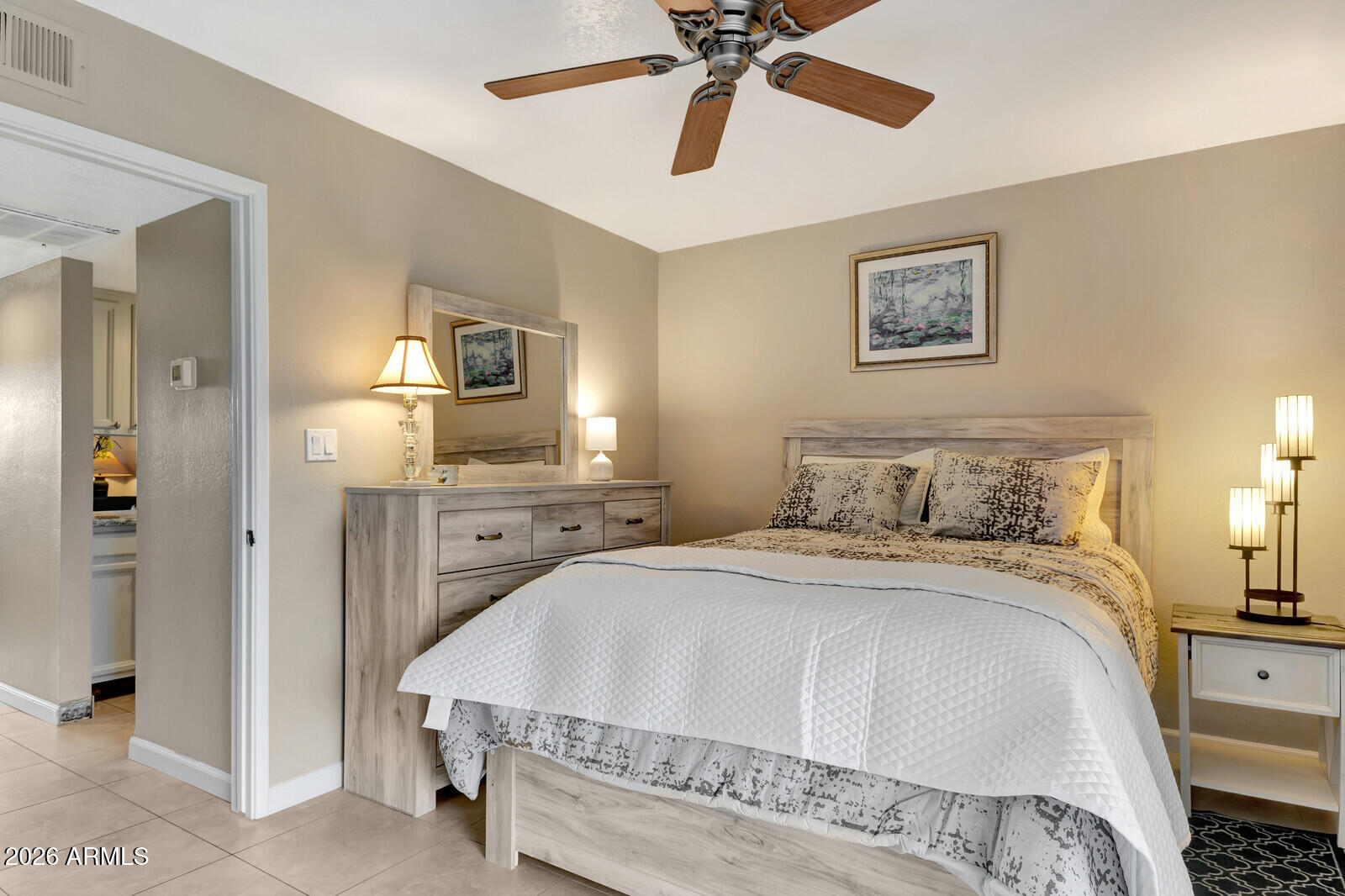 7436 East Chaparral Road, Unit B228 Scottsdale, AZ 85250 - Photo 15 of 17 a spacious bedroom with a bed and a chandelier