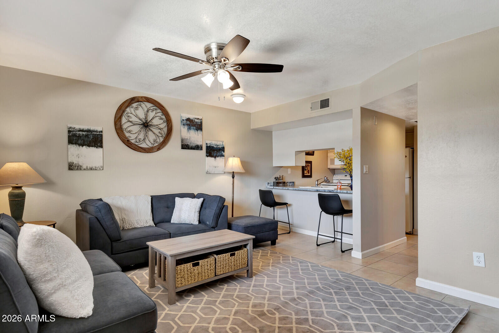7436 East Chaparral Road, Unit B228 Scottsdale, AZ 85250 - Photo 4 of 17 a living room with furniture a clock on wall and a table