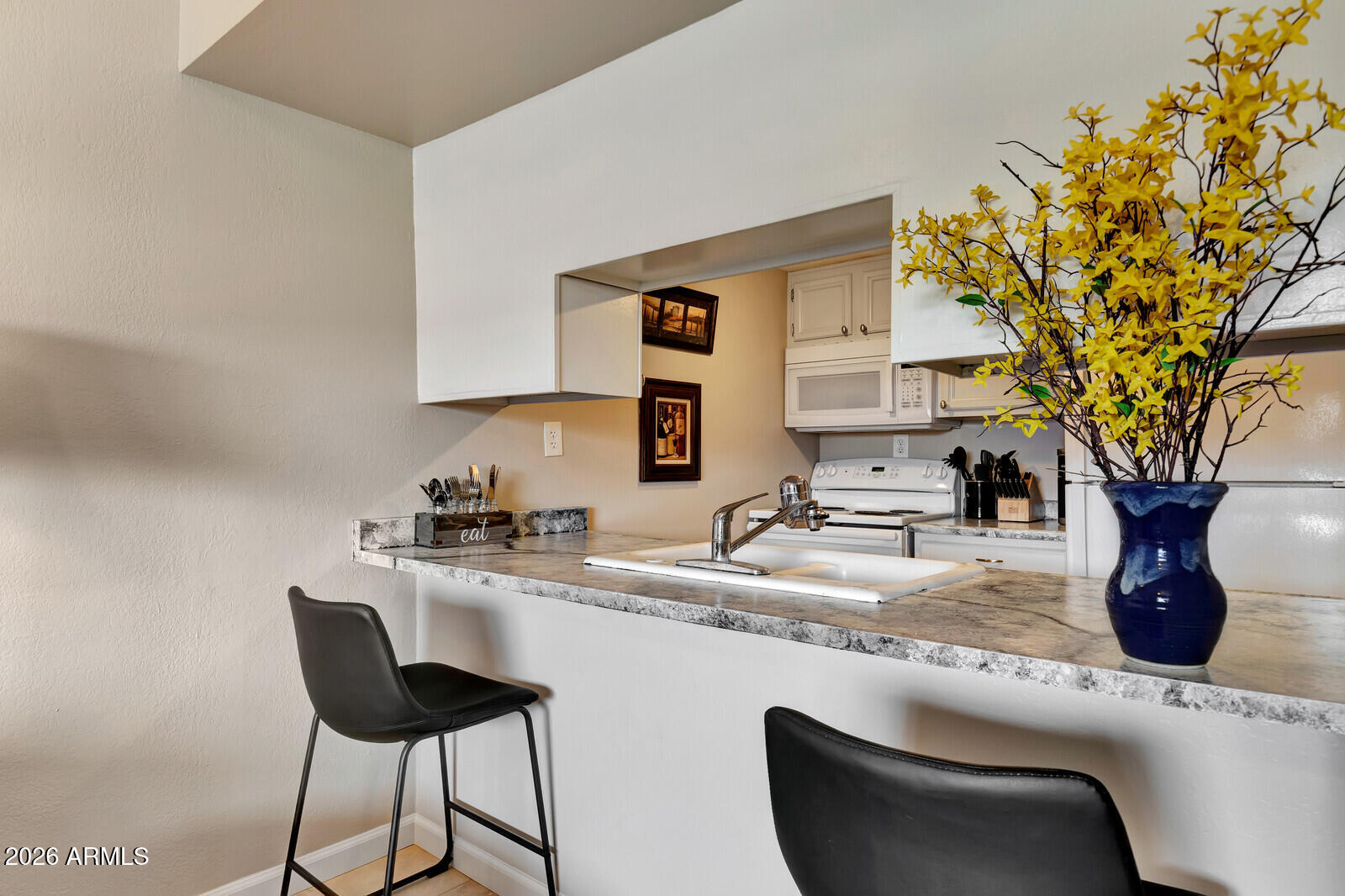 7436 East Chaparral Road, Unit B228 Scottsdale, AZ 85250 - Photo 9 of 17 a kitchen with a sink and a stove with wooden floor