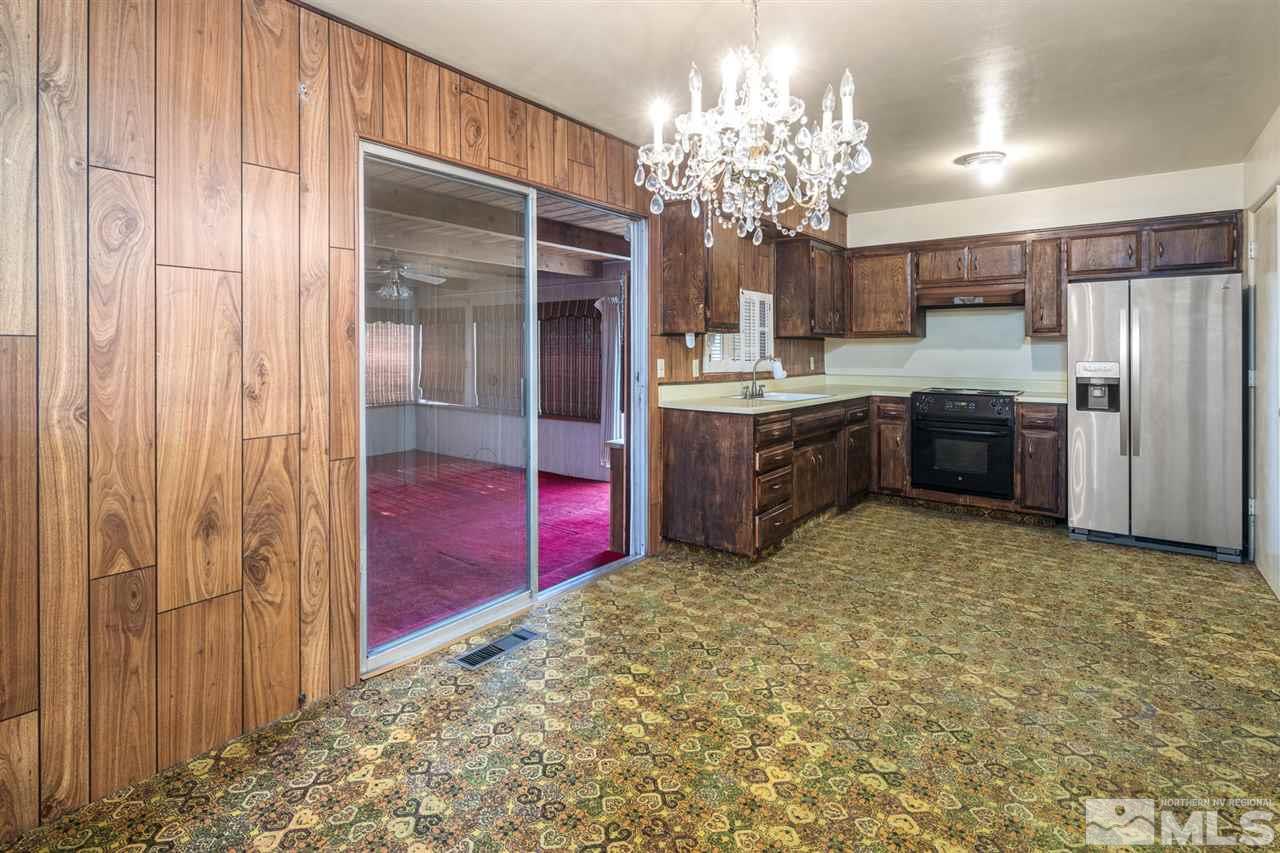 405 Gregory Way Sparks, NV 89431 - Photo 5 of 24 a large kitchen with kitchen island granite countertop cabinets and stainless steel appliances