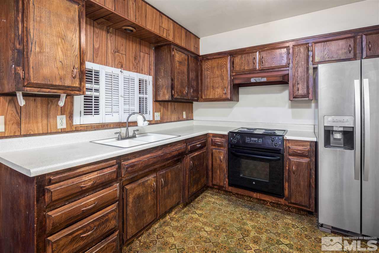 405 Gregory Way Sparks, NV 89431 - Photo 6 of 24 a kitchen with stainless steel appliances granite countertop a refrigerator and a stove top oven