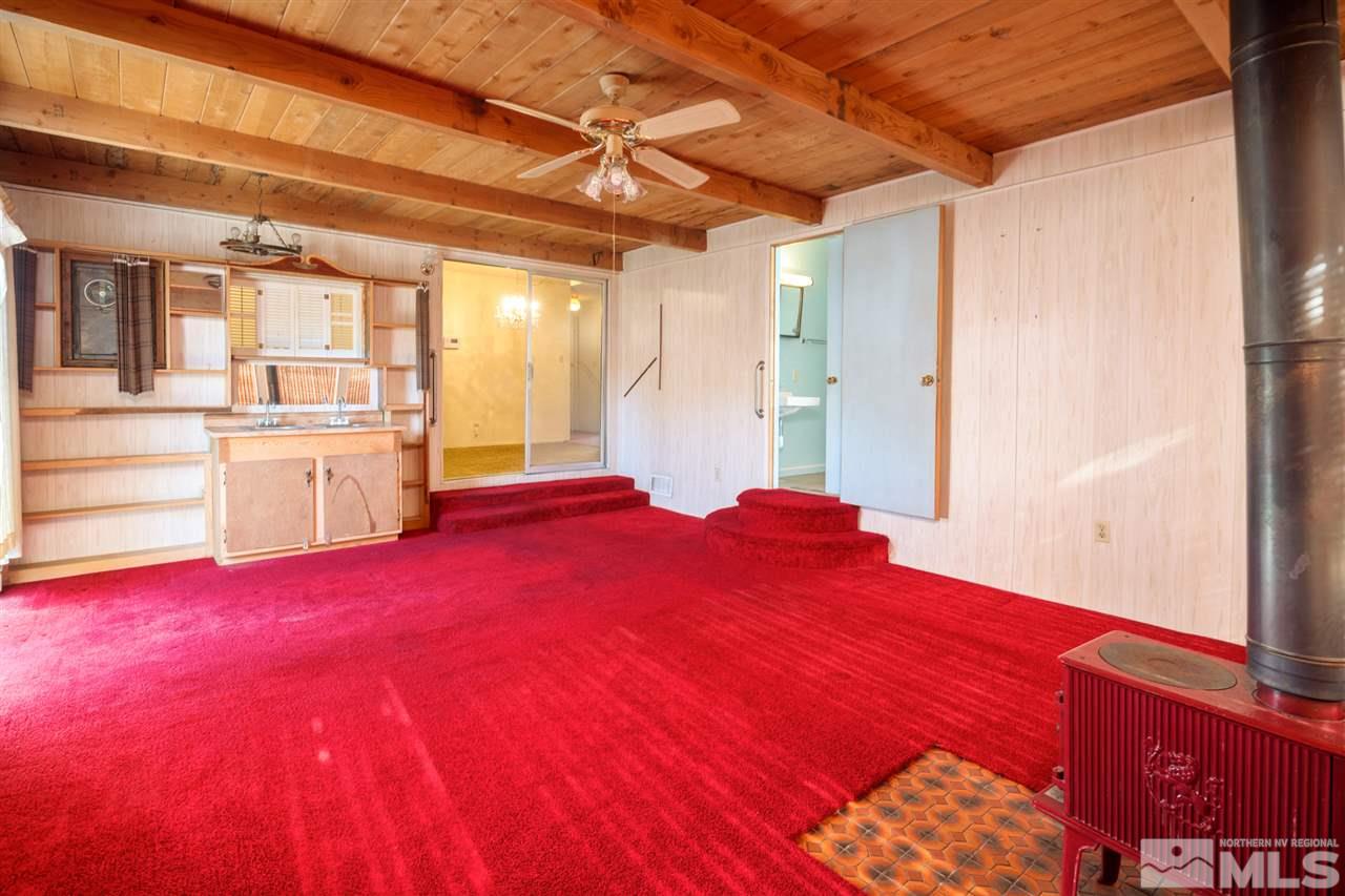 405 Gregory Way Sparks, NV 89431 - Photo 9 of 24 a bedroom with a bed and wooden floors