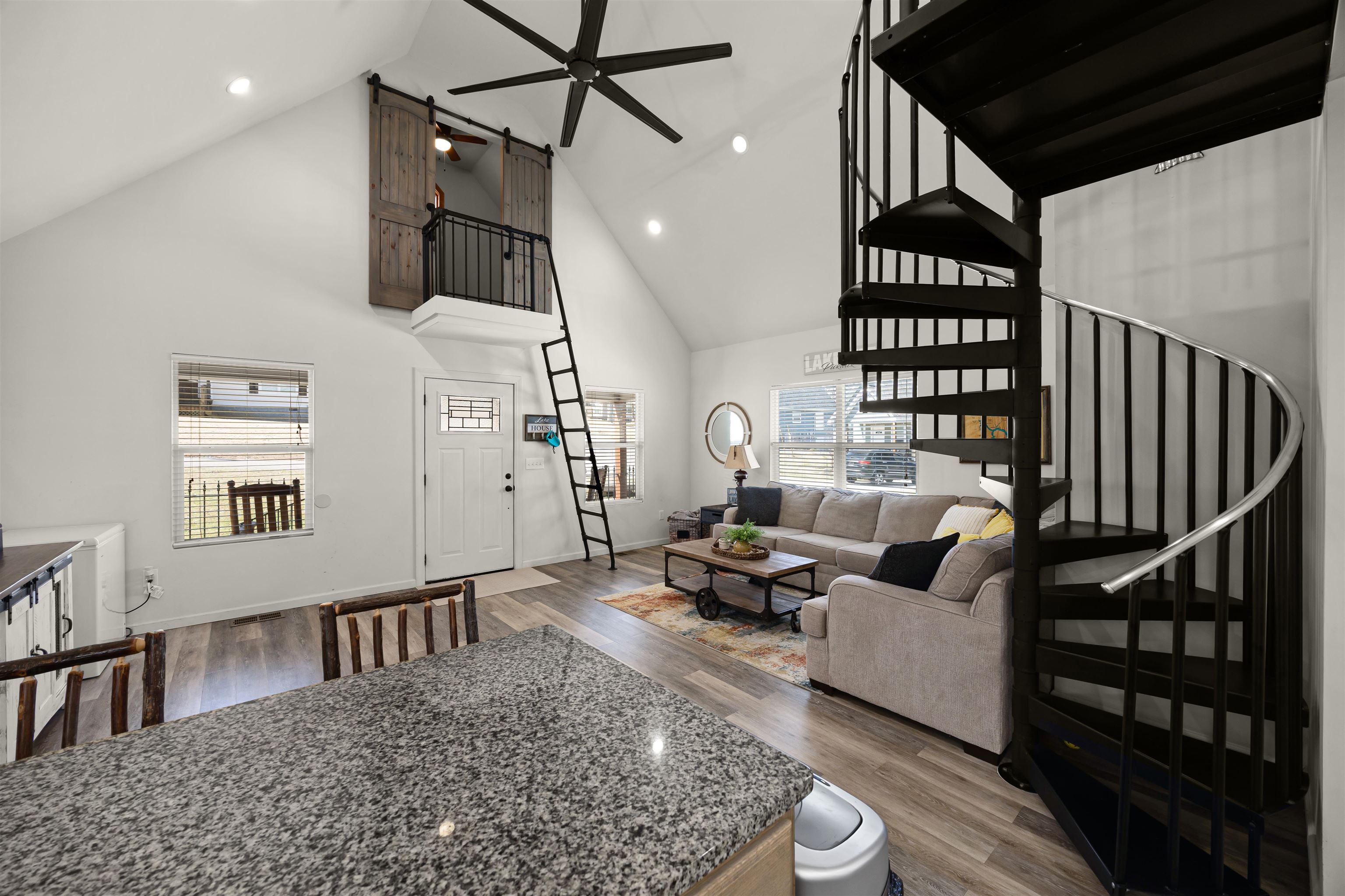 a living room with furniture ceiling fan and a rug